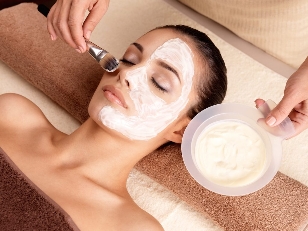 The beautician applies a refreshing mask